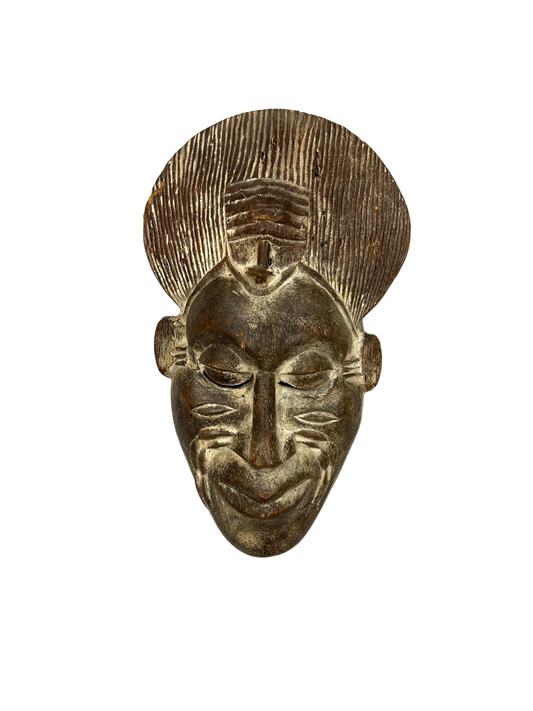 This masterful head sculpture, intricately carved from wood and accented with metal, exudes warmth and elegance, showcasing the artist's keen attention to detail. A stellar addition to any art collection, its expressive form and rich cultural resonance promise to captivate and inspire, available at the hearing clinic at Allard Audiology.