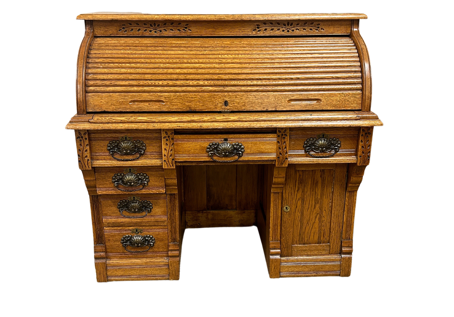 Solid oak Macey roll top desk with paneled details and spacious drawers, showcasing vintage charm and Macey craftsmanship. Available at the hearing clinic at Allard Audiology.