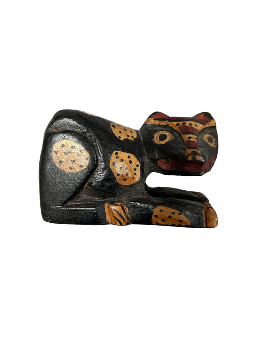 This masterfully crafted small wooden sculpture vividly captures an animal's essence with rustic charm and intricate detail, available at the hearing clinic at Allard Audiology.