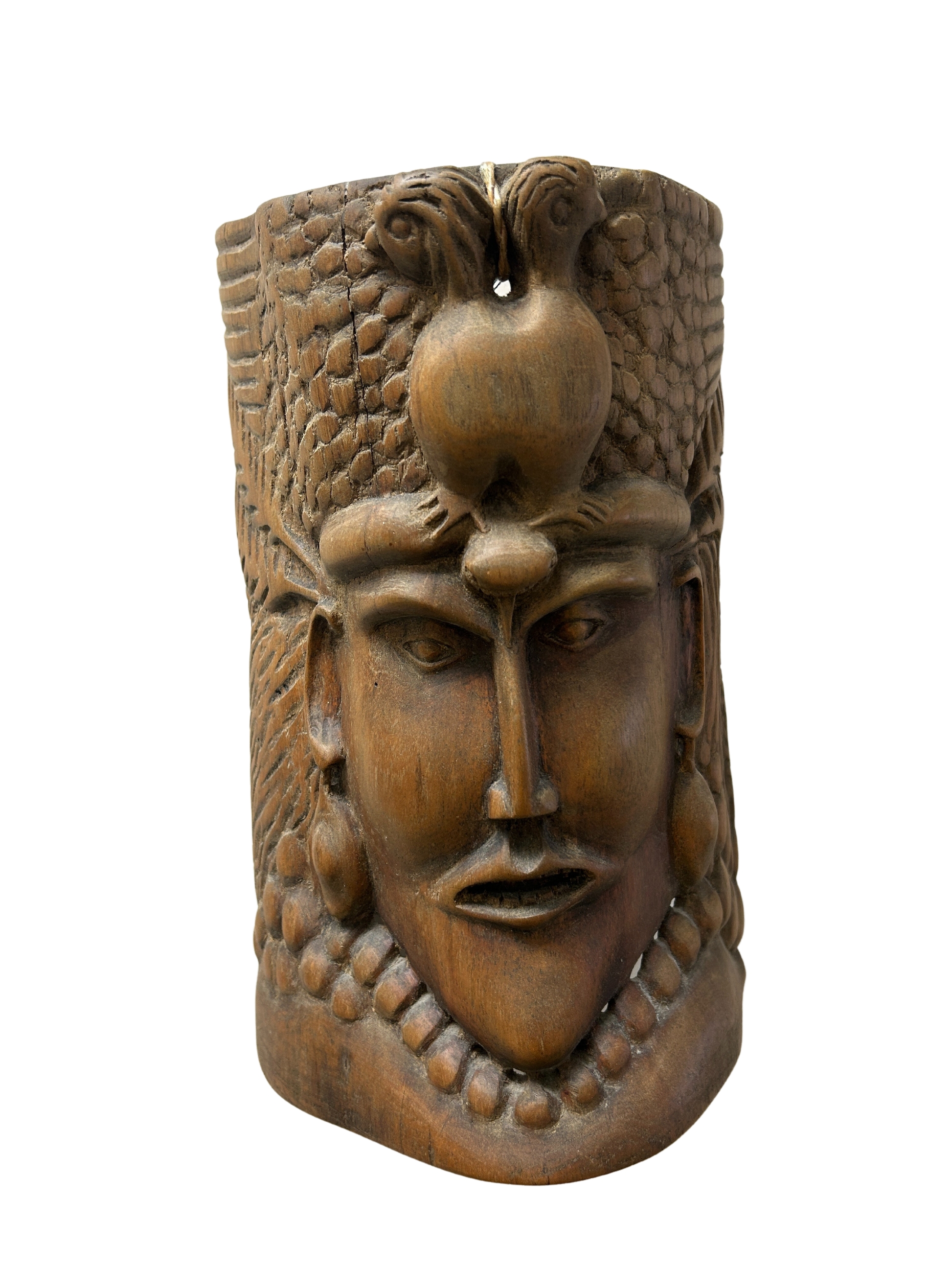 Wood mask with intricately carved jaw and relief details, blending ancient traditions with modern artistry as a culturally rich fashion accessory, available to benefit Allard Audiology.