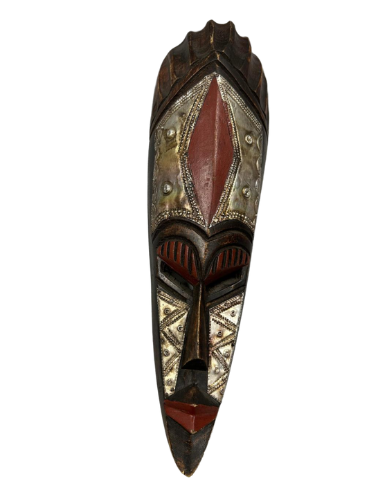 This intricately designed wooden mask, adorned with a captivating triangle pattern and a rich carmine hue, serves as a testament to masterful craftsmanship and cultural heritage, available at the hearing clinic at Allard Audiology. 